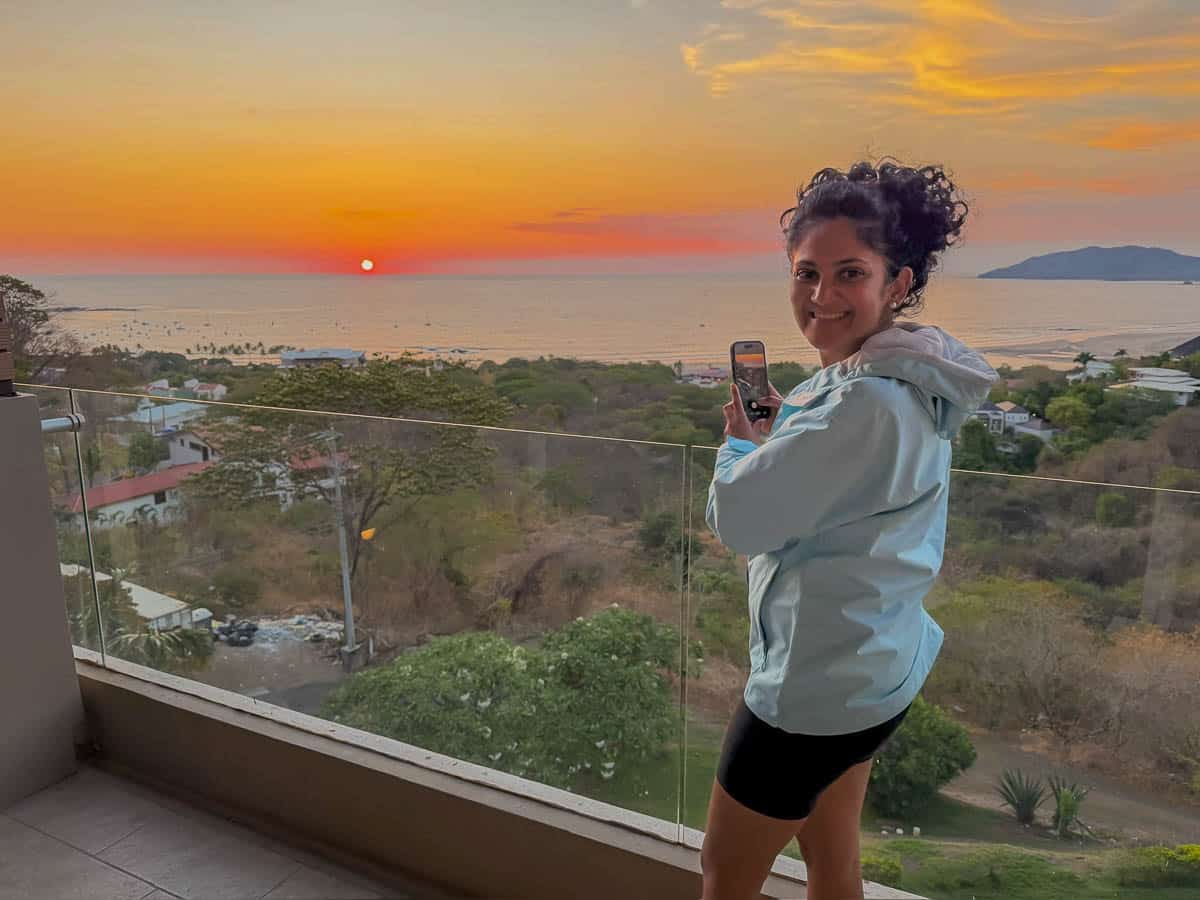 Reem smiling while watching the sunset from a balcony in Wyndham Tamarindo, Costa Rica.