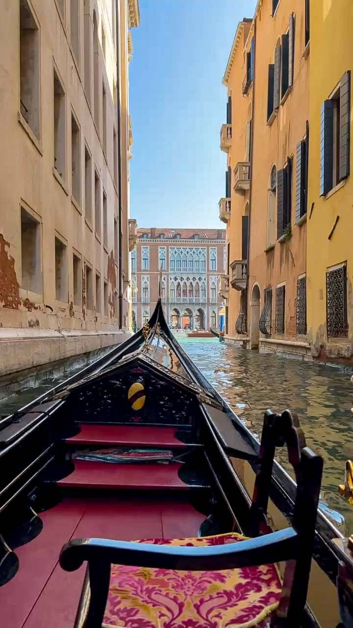 View from a gondola travelling through a narrow canal in Venice
