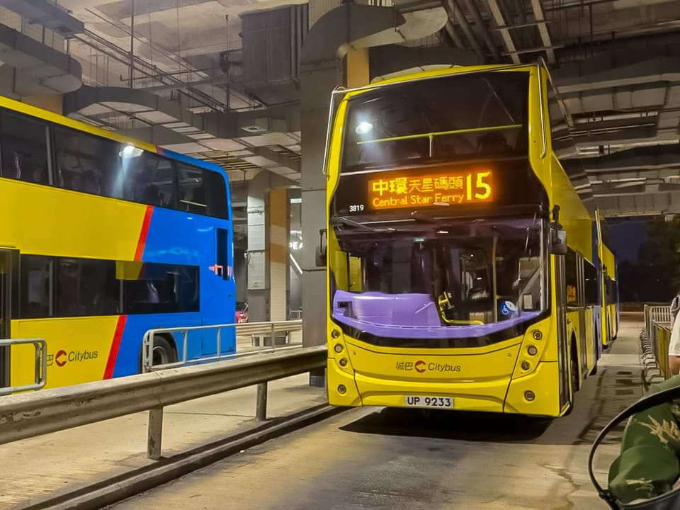 Yellow double-decker Citybus on route 15 at the covered bus terminal by Victoria Peak, displaying Central Star Ferry as its destination.