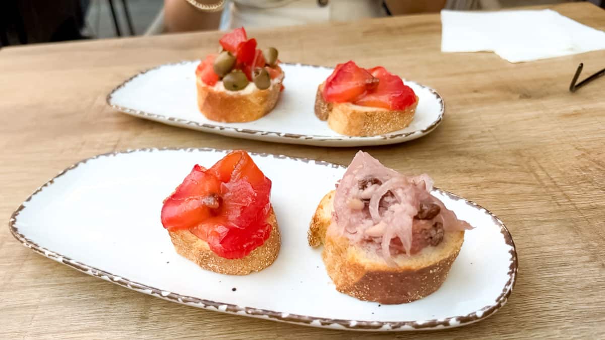 Assortment of Venetian cicchetti served on small slices of bread.