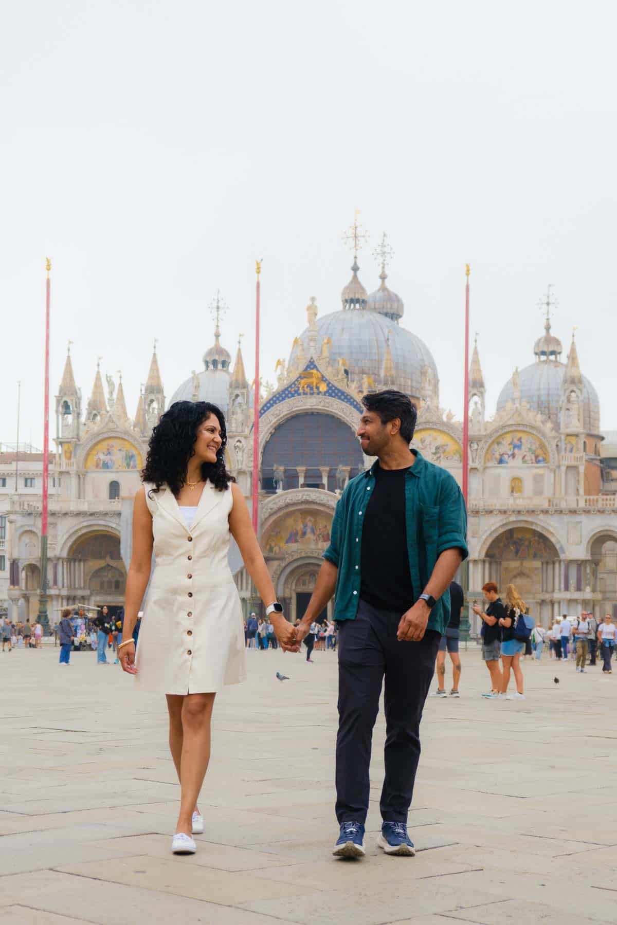 Riz and Reem walking in front of St. Mark's Basilica in Venice.