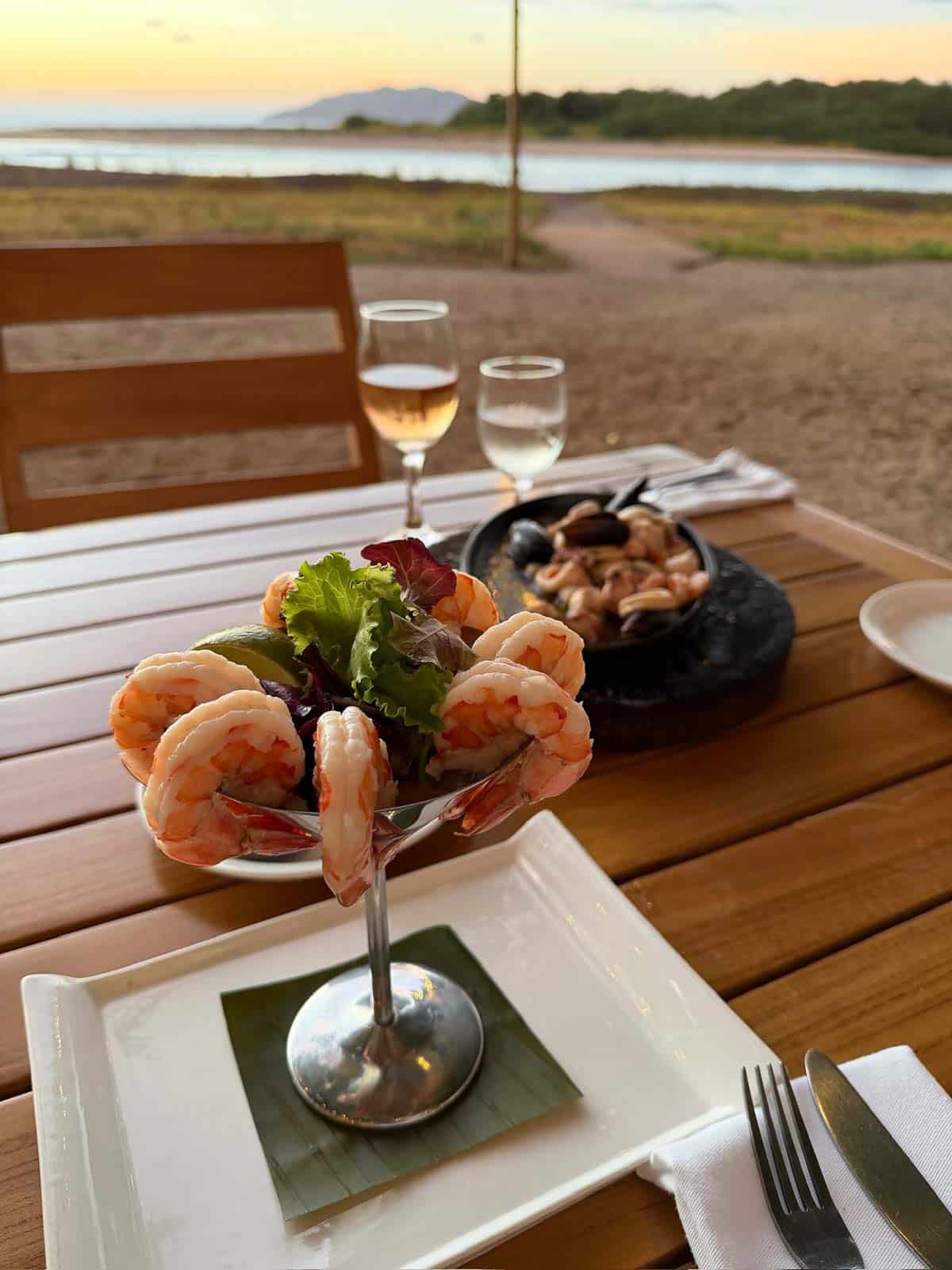 Shrimp cocktail and seafood dinner at a beachfront table at Pangas Beach Club in Tamarindo