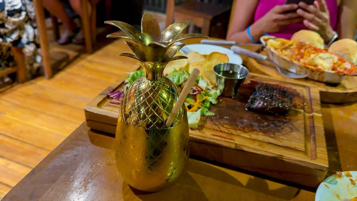 Steak dinner with a pineapple-shaped cocktail at Patagonia Argentinian Grill in Tamarindo