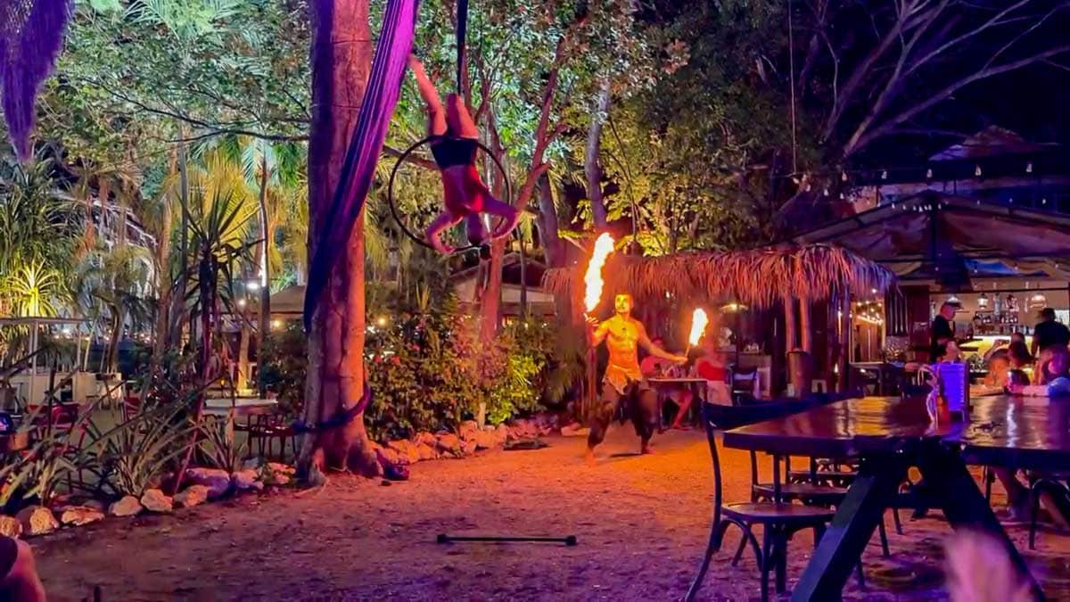 Aerial hoop performer and fire dancer entertaining guests at Namu Restaurant in Tamarindo